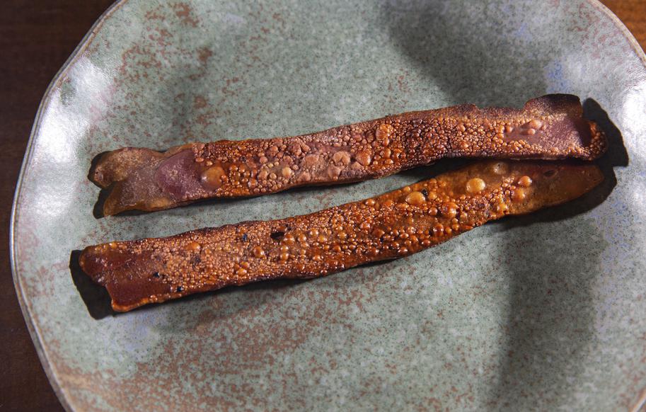 A plate with two pieces of Umaro's seaweed bacon