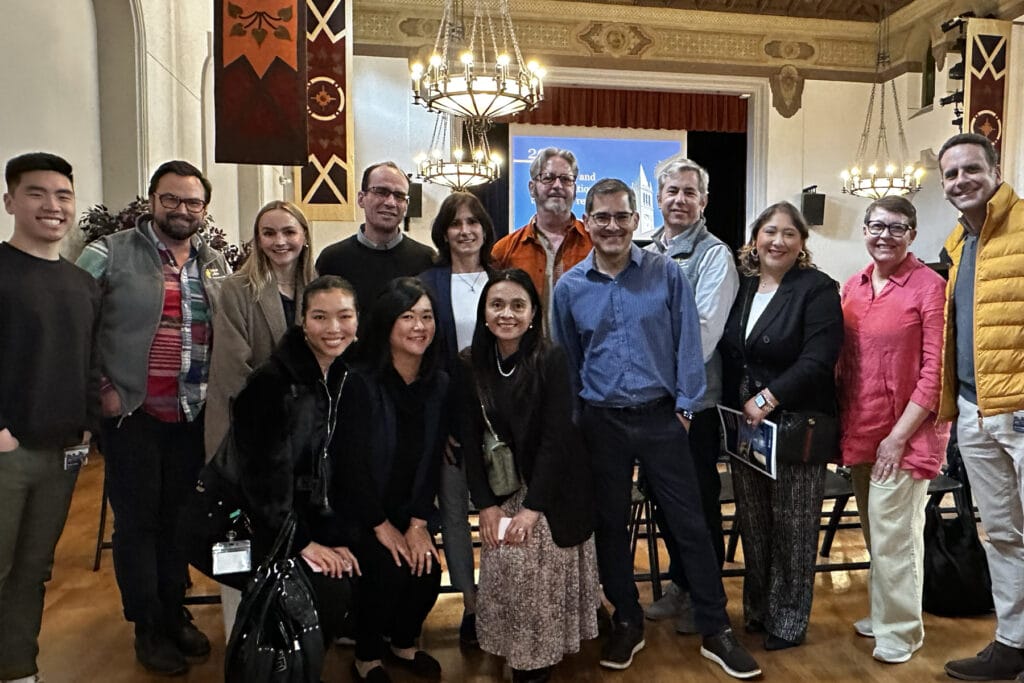 A large group of people celebrating in an informal group after winning an award